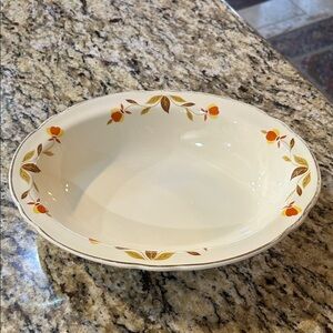 Vintage serving bowl is a Hall China Autumn Leaf 10-inch ruffled oval